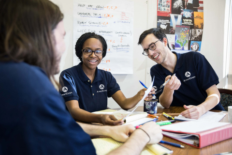 AmeriCorps members having a conversation at a table